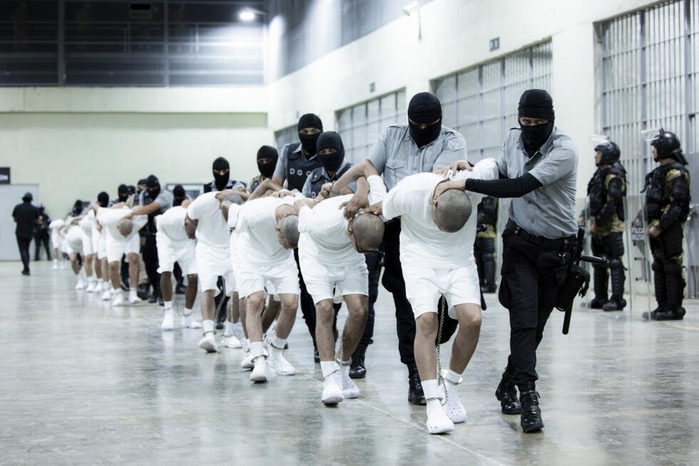 Prison guards transfer deportees from the U.S., alleged to be Venezuelan gang members, to the Terrorism Confinement Center in Tecoluca, El Salvador, Sunday, March 16, 2025.