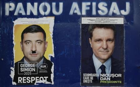 Una valla publicitaria muestra carteles electorales de los candidatos para la segunda vuelta de las elecciones presidenciales de 2025, en Bucarest 